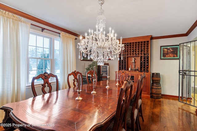 dining area with a notable chandelier, hardwood / wood-style flooring, and ornamental molding