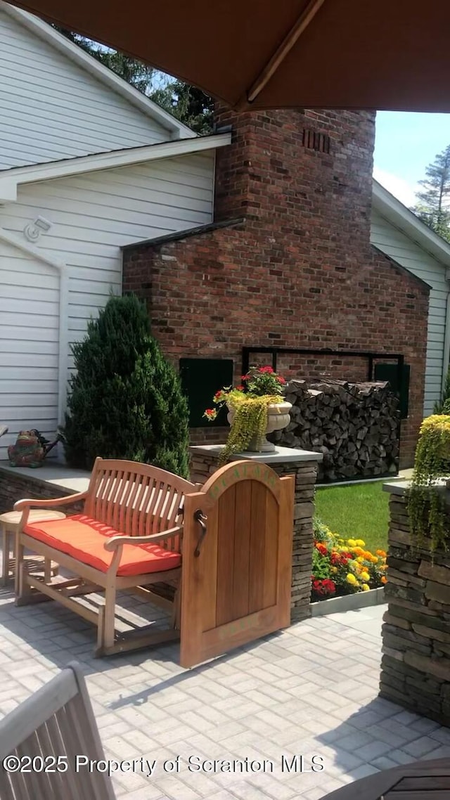 view of patio with a fireplace