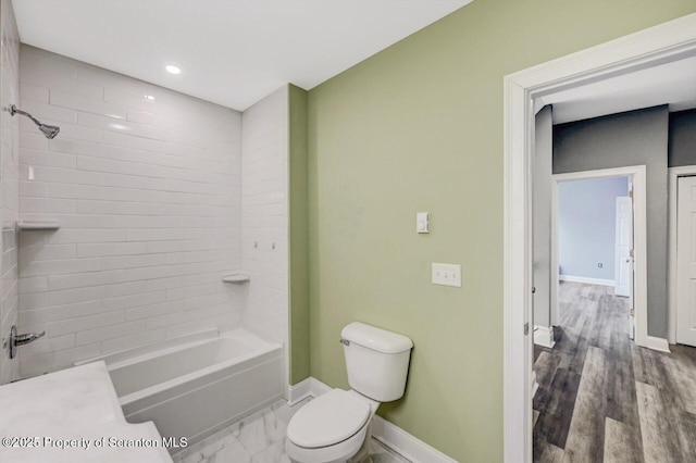 full bath with shower / washtub combination, marble finish floor, recessed lighting, toilet, and baseboards