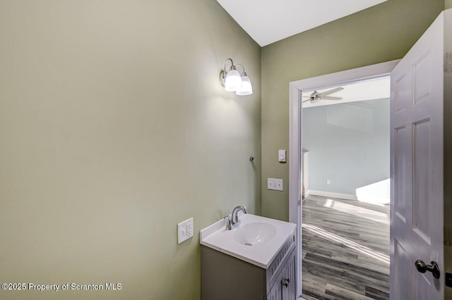 bathroom with ceiling fan, wood finished floors, and vanity