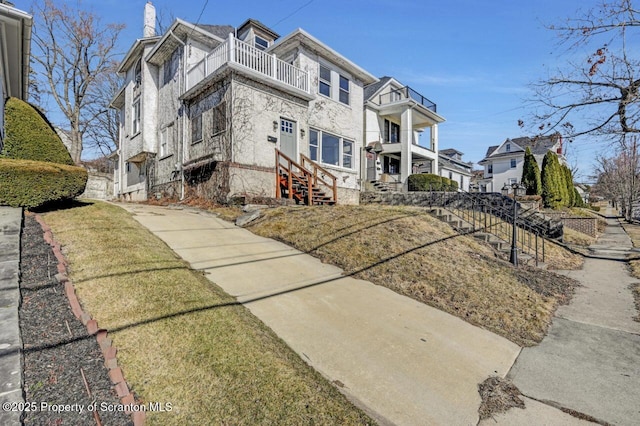 view of front of property with a balcony