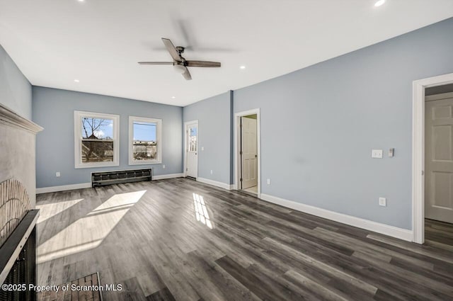 unfurnished living room featuring baseboards, a ceiling fan, wood finished floors, a fireplace, and recessed lighting