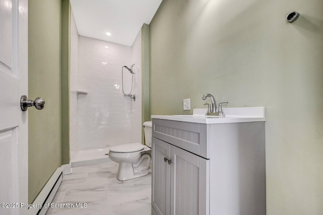 bathroom with toilet, vanity, marble finish floor, tiled shower, and baseboard heating