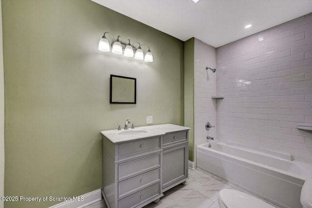 bathroom with marble finish floor, toilet, tub / shower combination, vanity, and baseboards