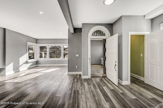 unfurnished living room featuring recessed lighting, wood finished floors, and baseboards