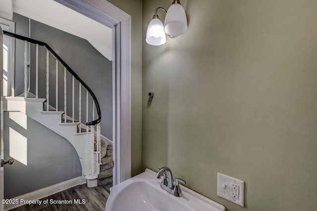 bathroom with baseboards, a sink, and wood finished floors