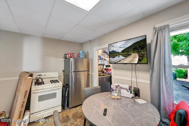 7 Oakwood Pl, Scranton, PA 18510 - kitchen with white gas range, freestanding refrigerator, a paneled ceiling, and tile countertops