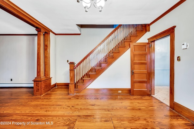 100 Short St, Edwardsville, PA 18704 - stairway featuring a baseboard heating unit, crown molding, and wood-type flooring