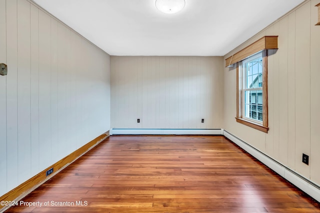 100 Short St, Edwardsville, PA 18704 - spare room featuring dark hardwood / wood-style floors, wood walls, and a baseboard heating unit