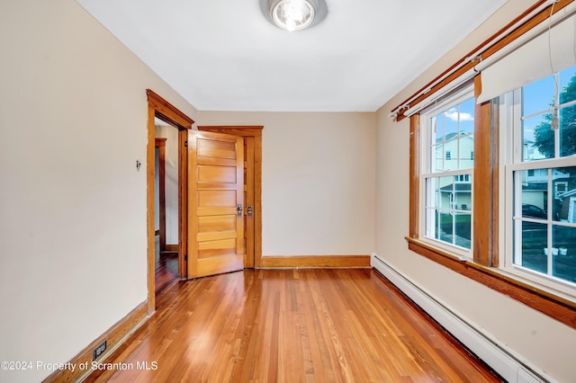 100 Short St, Edwardsville, PA 18704 - spare room with light hardwood / wood-style floors and a baseboard heating unit