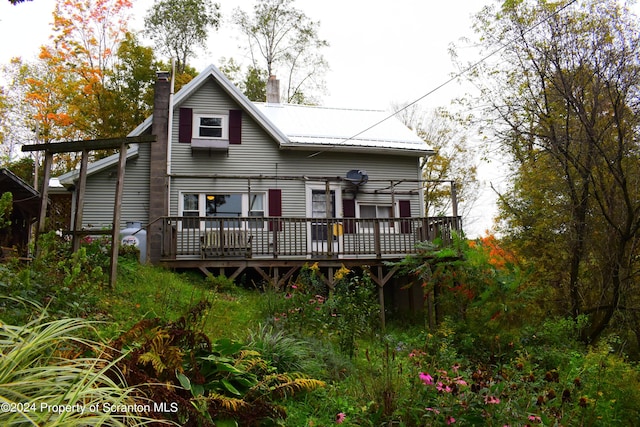 back of house with a deck