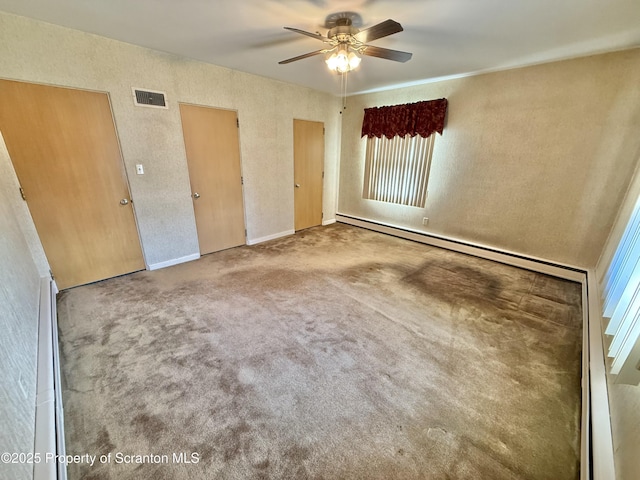 empty room featuring carpet flooring and ceiling fan