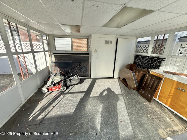 misc room with a paneled ceiling