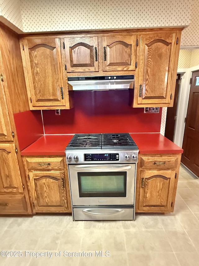 kitchen featuring light tile patterned floors and stainless steel range with gas cooktop