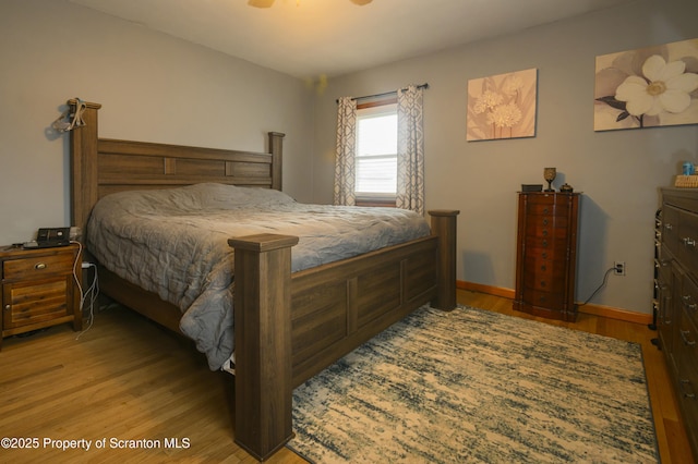 bedroom with wood finished floors and baseboards