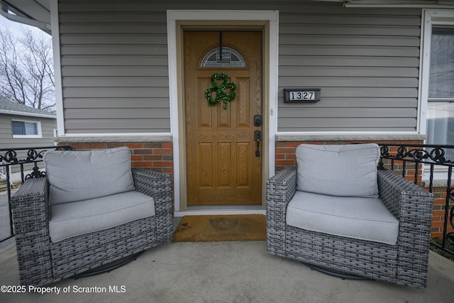 view of exterior entry with brick siding