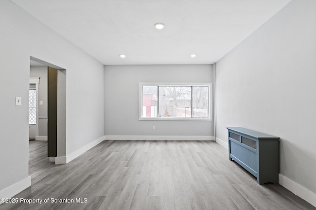 empty room with light hardwood / wood-style flooring