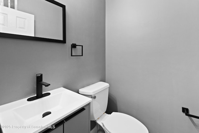 bathroom with toilet and vanity