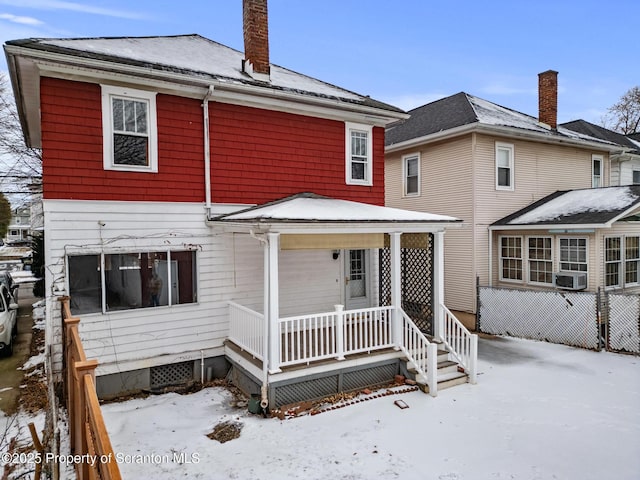 snow covered house with covered porch