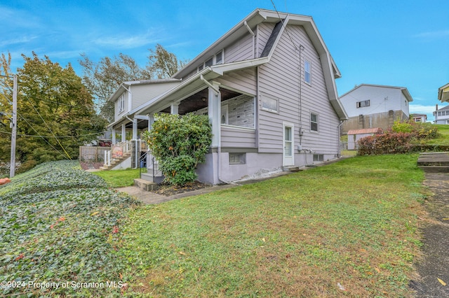 view of side of property with a lawn