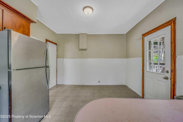 129-131 Main St, Dupont, PA 18641 - kitchen with freestanding refrigerator, light tile patterned floors, ornamental molding, and wainscoting