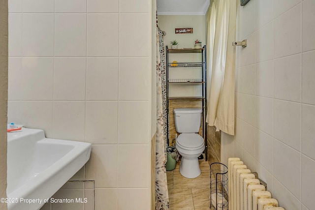 129-131 Main St, Dupont, PA 18641 - full bath featuring tile walls, radiator, toilet, ornamental molding, and a sink