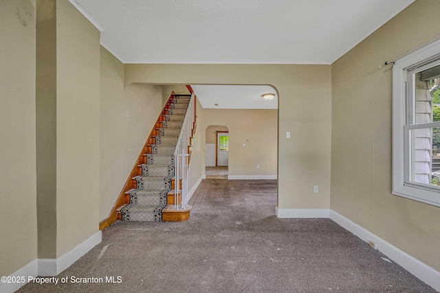 129-131 Main St, Dupont, PA 18641 - staircase featuring arched walkways, carpet, healthy amount of natural light, baseboards, and ornamental molding