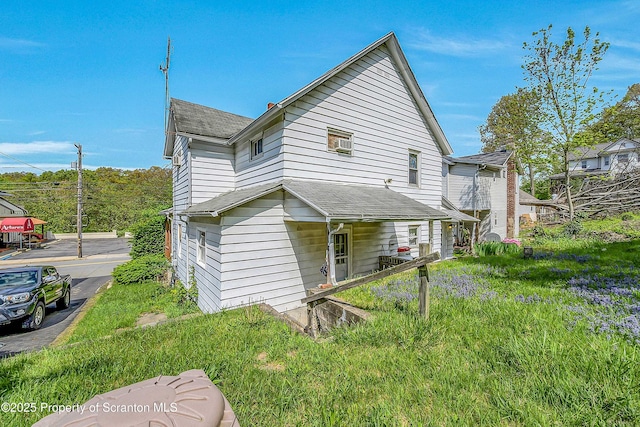 129-131 Main St, Dupont, PA 18641 - back of property featuring a shingled roof
