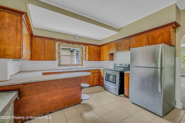 129-131 Main St, Dupont, PA 18641 - kitchen with stainless steel appliances, brown cabinets, light countertops, and healthy amount of natural light