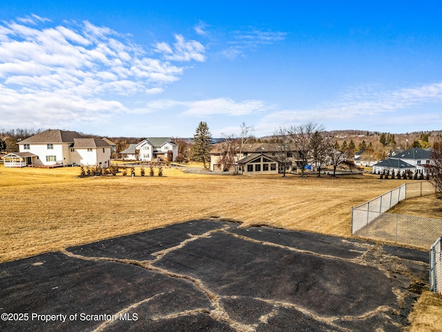 view of yard featuring a residential view and fence