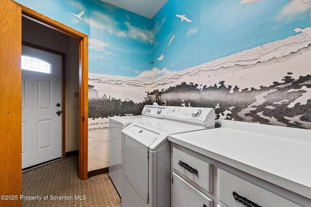 laundry area with cabinet space, tile patterned flooring, and washer and clothes dryer