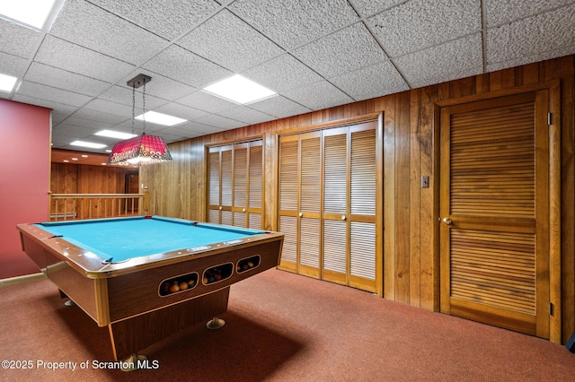 rec room with wooden walls, pool table, and carpet flooring