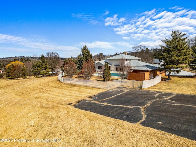 view of yard featuring a pool and fence