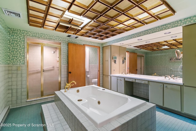 bathroom with tile patterned floors, visible vents, a stall shower, and a baseboard radiator