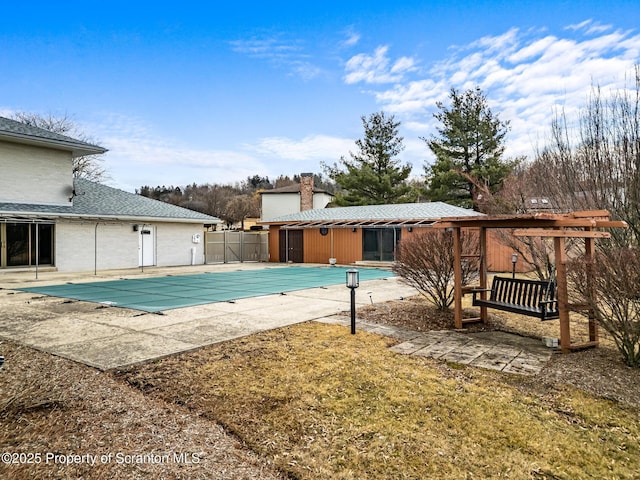 view of swimming pool with a fenced in pool, a patio, and fence