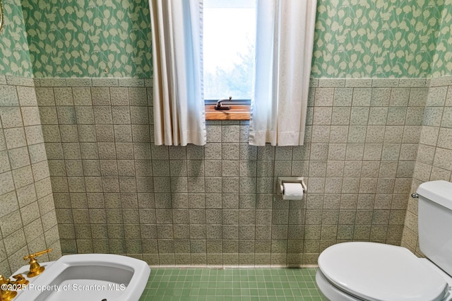 half bathroom featuring tile walls and toilet