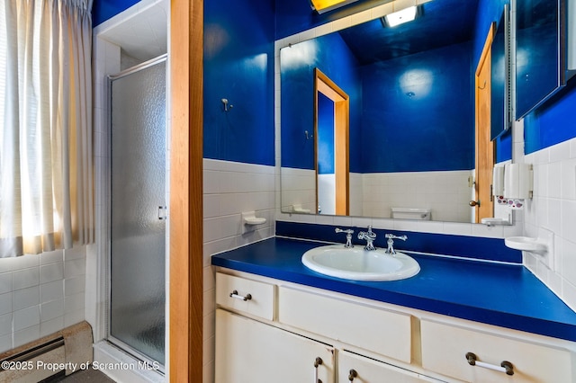 full bathroom with vanity, tile walls, toilet, and a stall shower