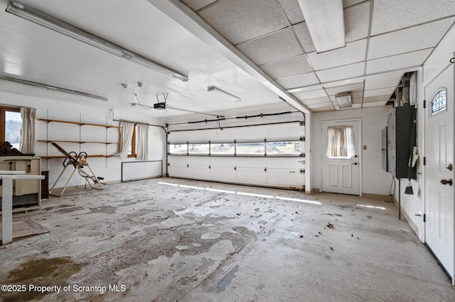 garage with electric panel and a garage door opener