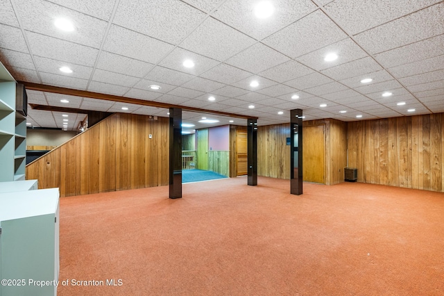 finished below grade area featuring recessed lighting, wood walls, and carpet