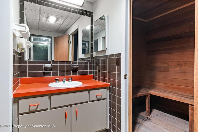 bathroom featuring vanity, tile walls, and a sauna