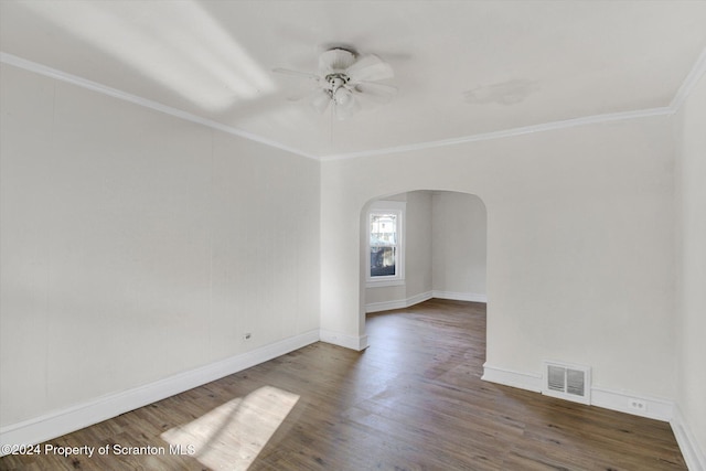 empty room with crown molding, ceiling fan, and dark wood-type flooring