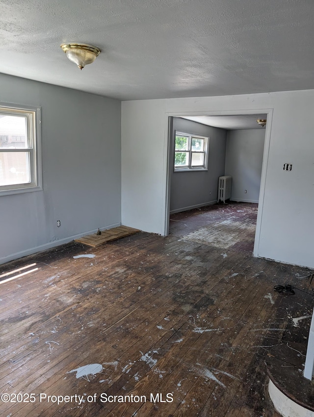 819 Luzerne St, Scranton, PA 18504 - unfurnished room with radiator, hardwood / wood-style floors, and a textured ceiling