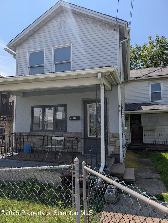 819 Luzerne St, Scranton, PA 18504 - view of front of property featuring a porch, a fenced front yard, and stucco siding