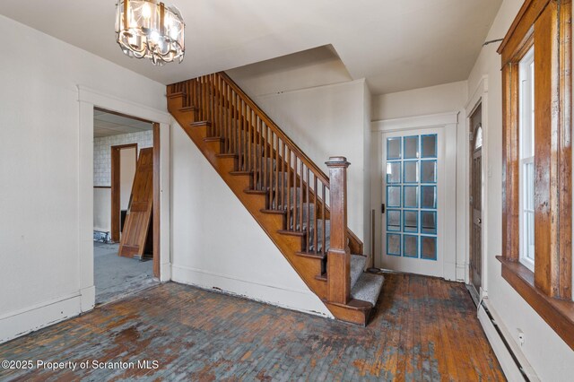 347 Orchard St, Old Forge, PA 18518 - entrance foyer featuring a notable chandelier, stairway, baseboard heating, and wood-type flooring
