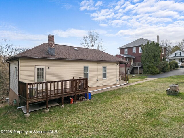 347 Orchard St, Old Forge, PA 18518 - back of house featuring a shingled roof, a deck, and a lawn