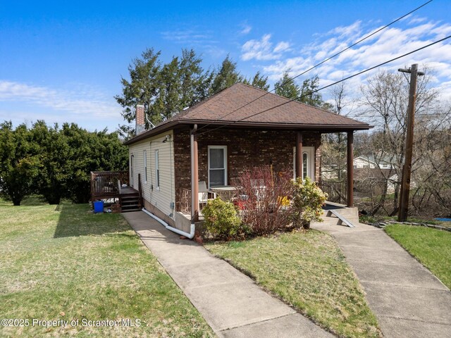 347 Orchard St, Old Forge, PA 18518 - view of front of house with a front yard, a porch, and a chimney