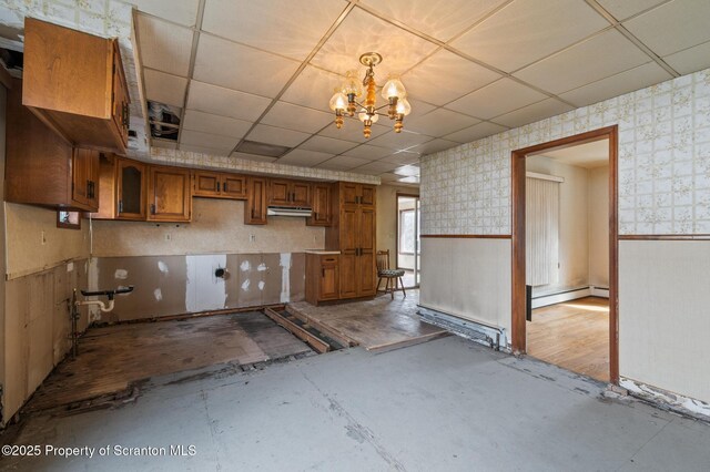 347 Orchard St, Old Forge, PA 18518 - interior space featuring a paneled ceiling, wallpapered walls, a wainscoted wall, baseboard heating, and brown cabinets