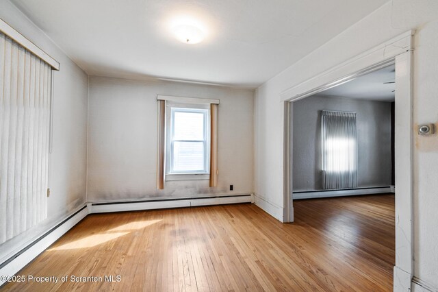 347 Orchard St, Old Forge, PA 18518 - unfurnished room featuring a baseboard radiator and hardwood / wood-style flooring
