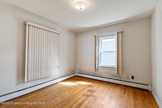 347 Orchard St, Old Forge, PA 18518 - unfurnished room featuring hardwood / wood-style floors and a baseboard radiator