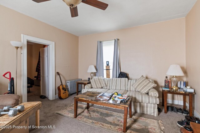 347 Orchard St, Old Forge, PA 18518 - living room featuring carpet flooring, baseboards, a ceiling fan, and radiator